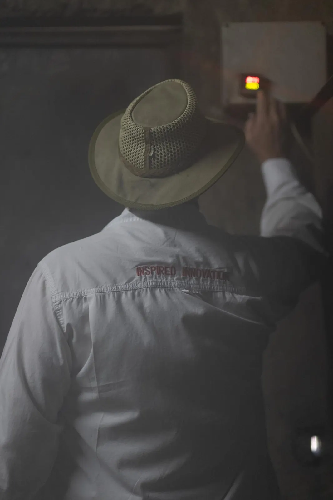 A ROC team member adjusting the controls inside a curing tunnel while explaining how it runs
